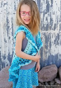 Crochet Circle Vest - I love circle vests! They're such a fun accessory. For this Crochet Circle Vest Pattern I wanted to use a Caron Cake. Because who doesn't love stripes without weaving in all the ends, amiright?